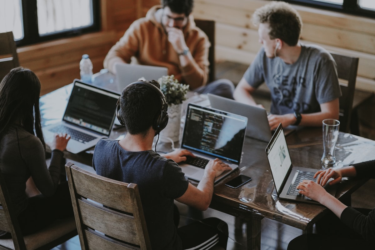 Team building at laptops around a table